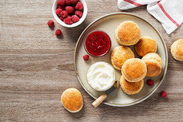Scones with raspberry jam and clotted cream.	
