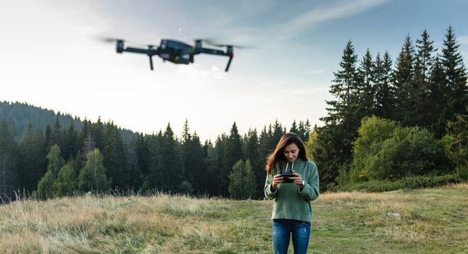 Young, beautiful woman piloting a drone