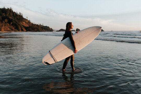 Girl walking with surfboard