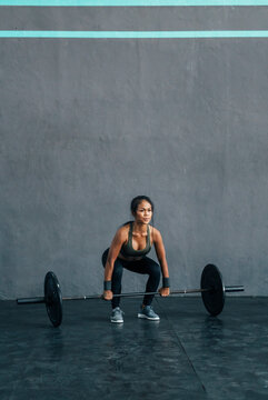 Woman lifting weights at gym