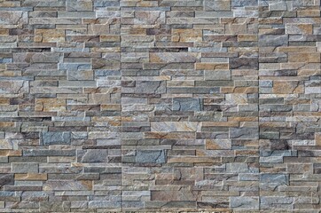 Exterior wall made of stoneware paneling  with natural stone effect. Background and texture