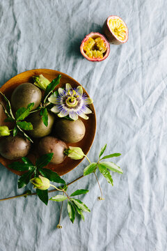 Plate of passionfruit with flowers and foliage