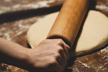 Frau rollt frischen Plätzchenteig mit Nudelholz aus. Close up. Nr.2