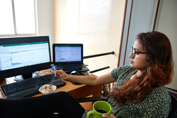 woman with glasses working with laptop