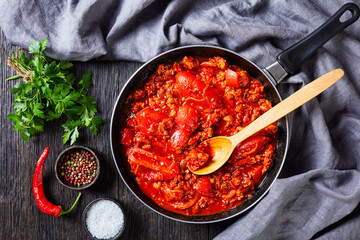 ragout with whole plum tomatoes and pork sausages
