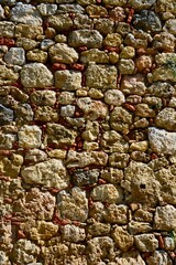 Close up of a wall showing different coloured and sizes of stone