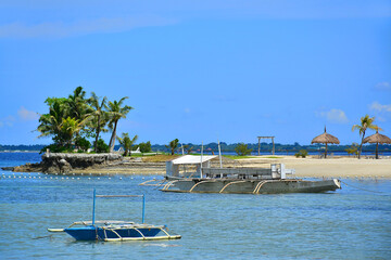 Fototapeta premium Cebu White Sands beach resort with boats in Cebu, Philippines