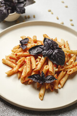 Pasta with tomatoes and Basil with cashews. Italian homemade pasta.