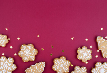 Obraz na płótnie Canvas Christmas gingerbread snowflakes on a dark red background
