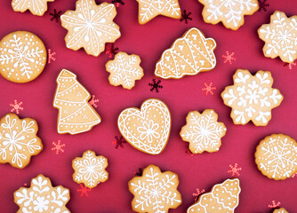 Christmas gingerbread snowflakes and Christmas trees on a dark red background