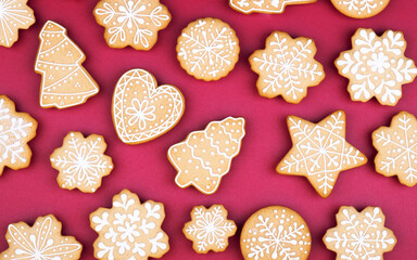 Christmas gingerbread snowflakes and Christmas trees on a dark red background