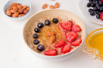 breakfast with porridge decorated with strawberries and blueberries