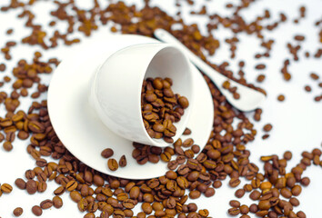 white coffee Cup and coffee beans on a white background, the concept of cheerfulness