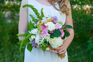 Beauty wedding bouquet in bride's hands. Wedding.