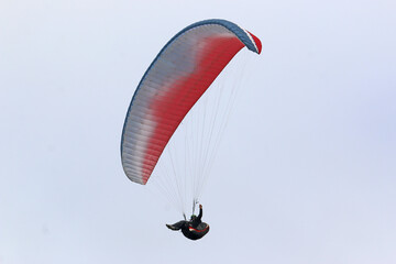 Paraglider flying wing in a blue sky	