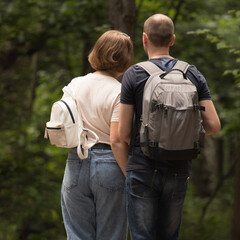 COUPLE WALKING IN THE SUMMER FOREST