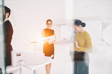 Young attractive female secretary dressed in elegant formal outfit and eyewear presenting rebranding strategy for leaders of company department reading report to discuss advantages and disadvantages