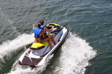 Fototapeta premium Couple riding tandem on a jetski