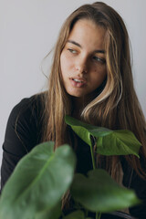 woman holding a green leaf