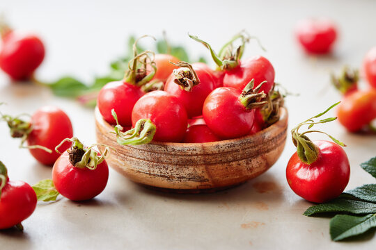 Rosehips berries in small wooden bowl
