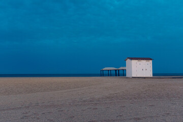 beach hut on the beach at sunset