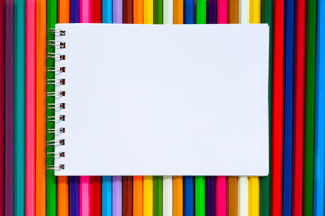 Paper note on colorful multicolor pencils flat lay, top view, back to school, copy space, mockup