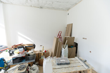 Interior of apartment with materials during on the renovation and construction, remodel wall from gypsum plasterboard or drywall
