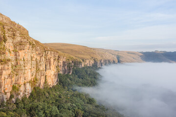 Fototapeta na wymiar Dawn with fog at Guartela Canyon - sixth largest canyon in the world in length - Tibagi/ Parana - Brazil