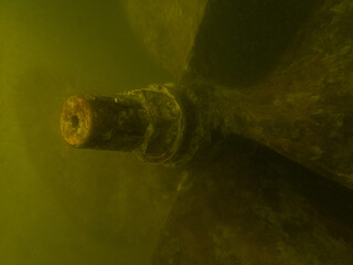 Fishing trawler propeller in murky water