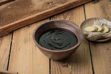 Teriyaki sauce in a wooden bowl on a wooden table