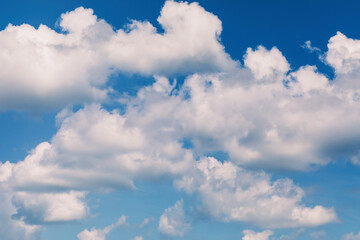 A fragment of white clouds in the blue sky in defocus for use as a background