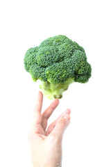 Woman's hand reaches for broccoli on white background