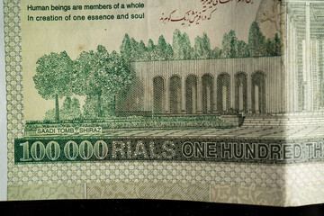 Iranian Rial (IRR). Close-up detail of banknotes and coin. Top view.