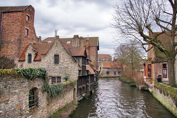 Fototapeta na wymiar Canal between old houses of famous Flemish medieval city Brugge. Bruges, Belgium