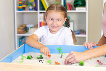 girl playing in the sand, educational activity with a child