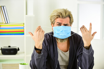 Man hold face mask. Virus is transmitted by droplets and close contact. Wearing mask Protect from...