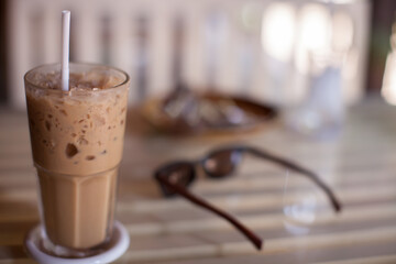 Ice coffee in glass on table