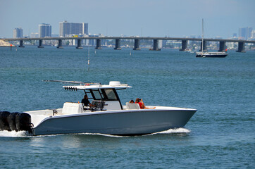 Upscale sport fishing boat leisurely cruising on the Florida Intra-Coastal Waterway off of Miami...