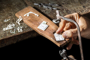 Craftsman cutting a piece of butterfly mop inlay