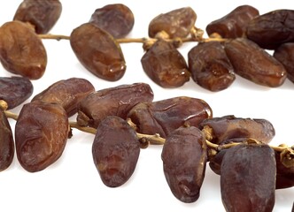 DRY DATE PALM FRUIT phoenix dactylifera AGAINST WHITE BACKGROUND