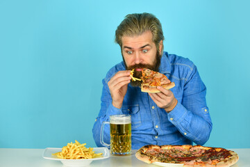 Pizzeria restaurant. Dinner at pub. Hungry man going to eat pizza and drink beer. Pizza party concept. Delivering happiness into mouth. Beer and food. Cheerful man bearded hipster eat pizza