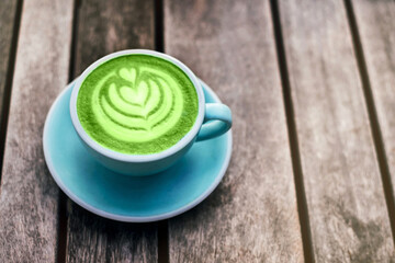 Fresh flavored green matcha on wooden background.