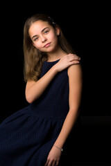 Naklejka premium Close-up.Portrait of a cute little girl on a black background.