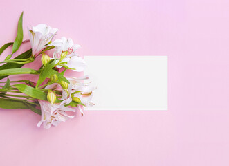 Business card on pink pastel background decorated with white flowers bouquet. Business woman template. Mock up. Space for text. Place for text. Flatlay