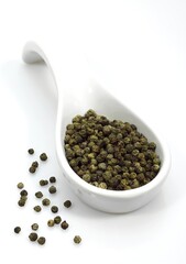 GREEN PEPPERCORN AGAINST WHITE BACKGROUND