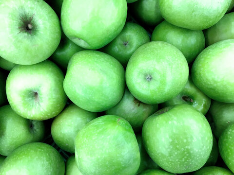 ripe green apples on the counter of a health food store