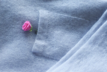 Knitted cardigan in pastel color, garment details, jacket pocket.