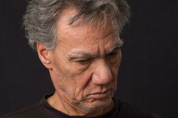 Obraz premium Distraught unshaven senior man at home looking depressed and tired of being locked down