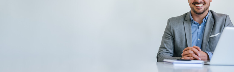 Banner panorama of faceless mid body section young smiling cheerful businessman entrepreneur in bright white modern office facing towards camera copy space for text - Powered by Adobe