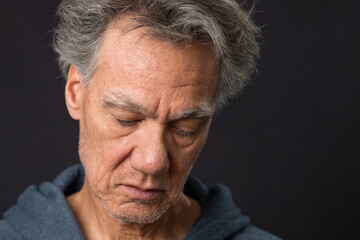  Distraught unshaven senior man at home looking depressed and tired of being locked down